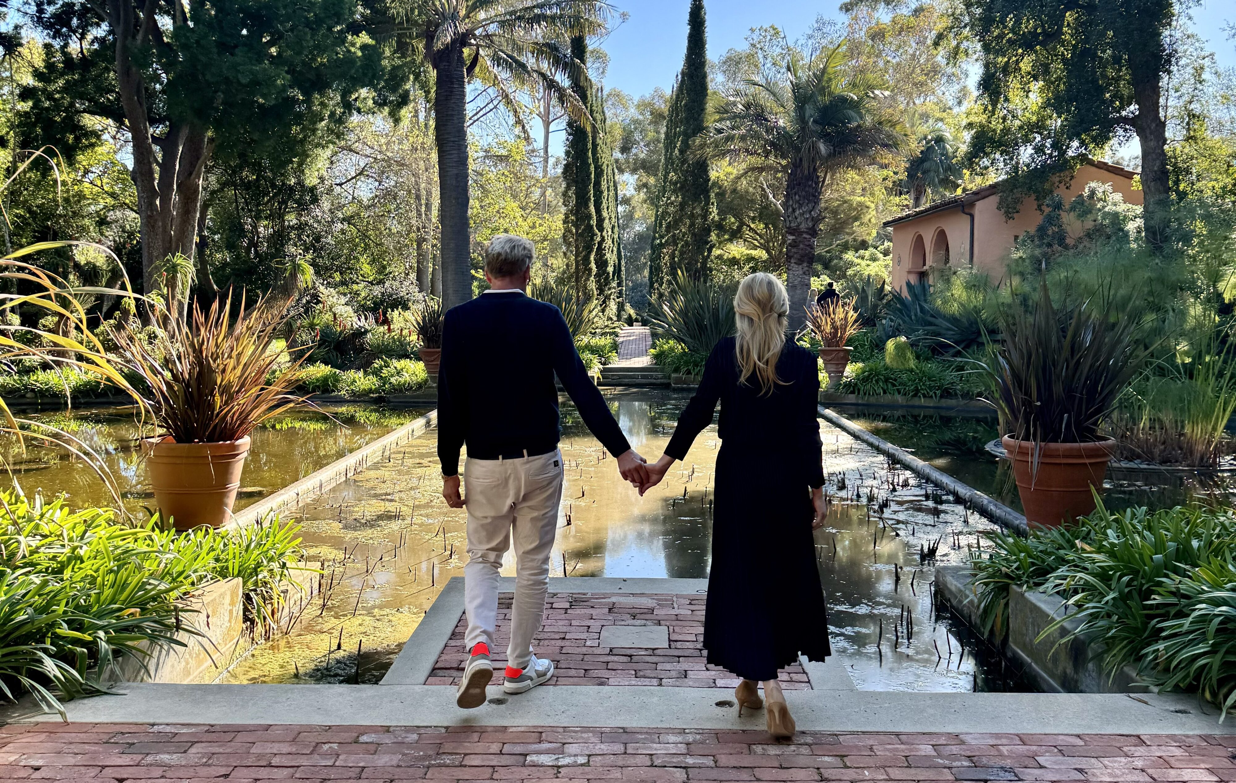 Couple holding hands in the Water Garden.